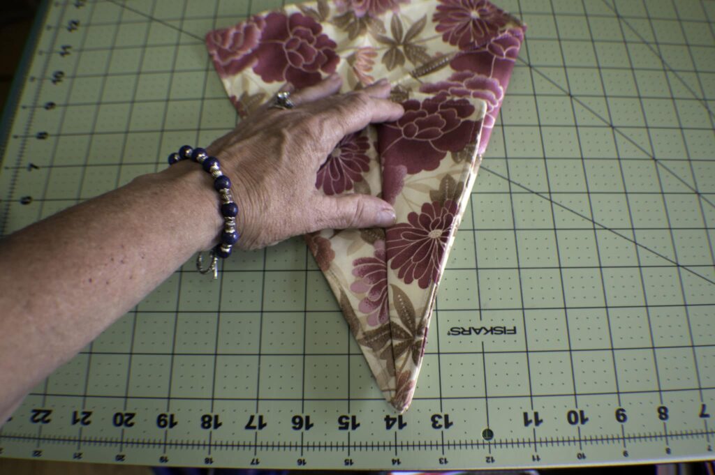 Fold half of the previous fold back on itself and press again Three Pocket Scissor Holder