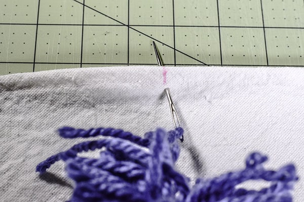 Make a drop cloth pom pom throw