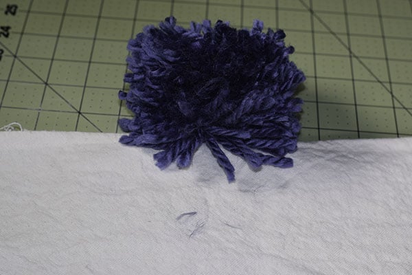 Make a drop cloth pom pom throw