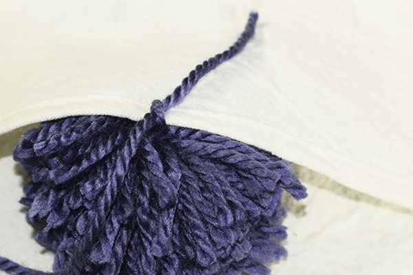 Make a drop cloth pom pom throw